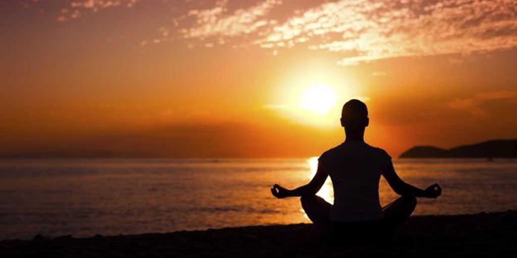 person meditating in a serene nature setting