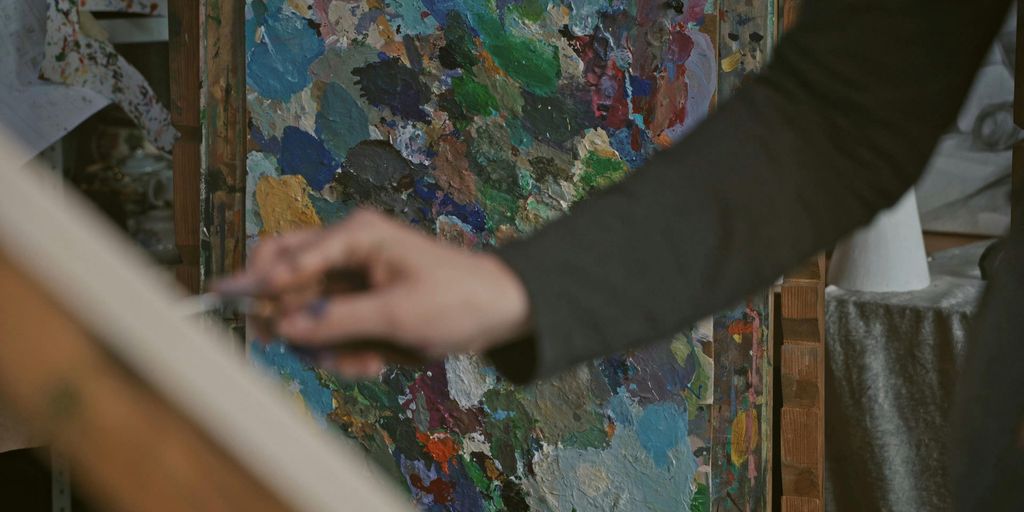 person painting in a serene studio with natural light